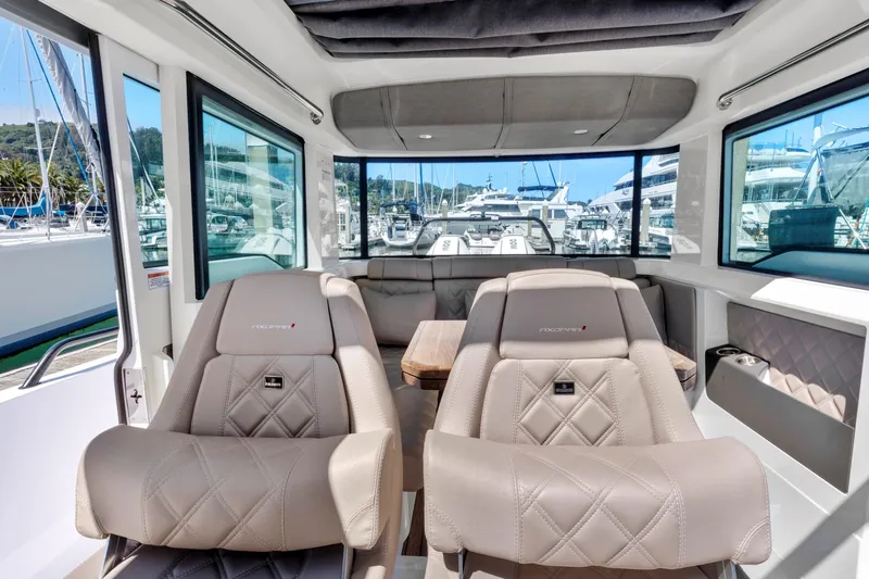 Slide: The Image of Interior of 2022 Axopar 37 Cross Cabin Brabus Trim, featuring luxurious seating and panoramic windows. - 7