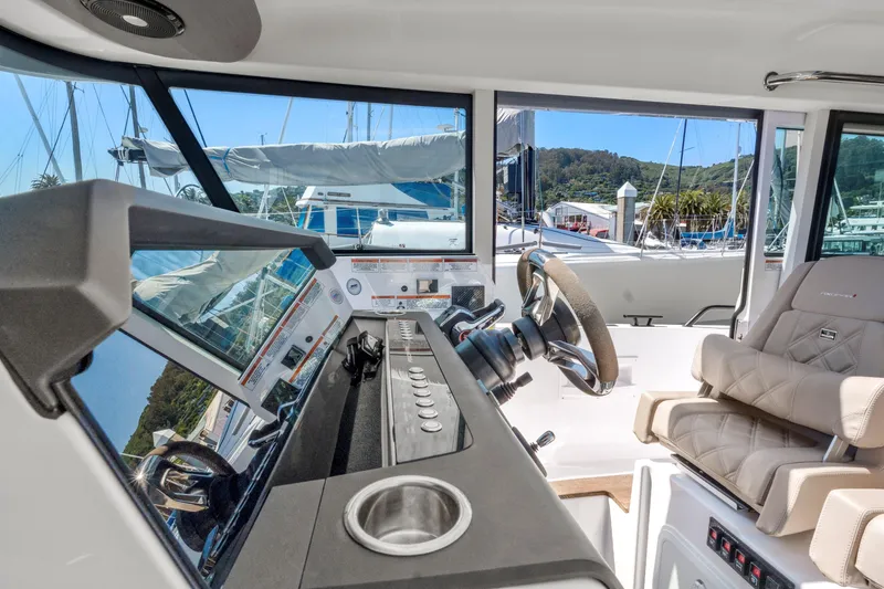 Slide: The Image of Interior of 2022 Axopar 37 Cross Cabin Brabus Trim with modern helm and seating. - 9