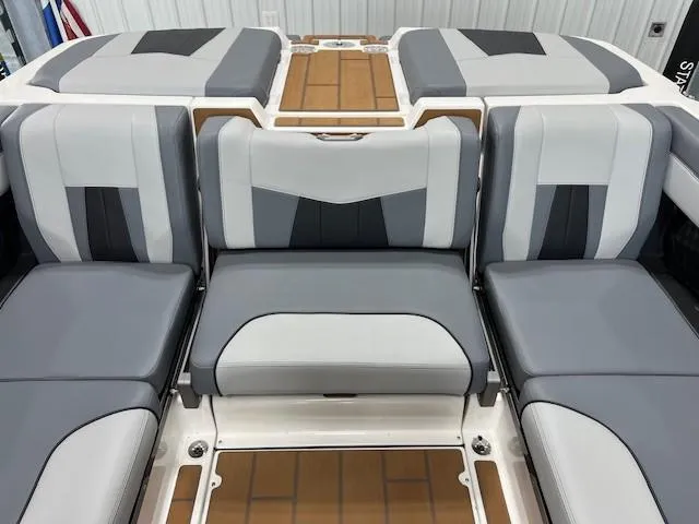 Slide: The Image of 2025 Malibu Wakesetter 24 MXZ interior with gray and white seating. - 12