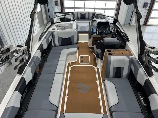 Slide: The Image of 2025 Malibu Wakesetter 24 MXZ interior with sleek seating and modern dashboard. - 13