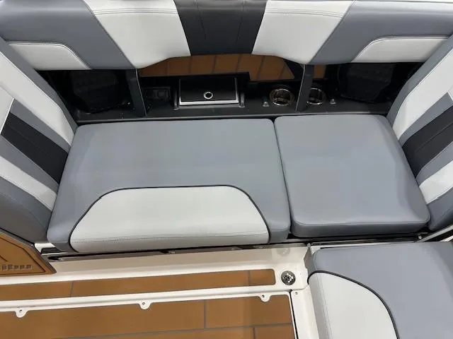 Slide: The Image of 2025 Malibu Wakesetter 24 MXZ interior seating with gray and white upholstery. - 14