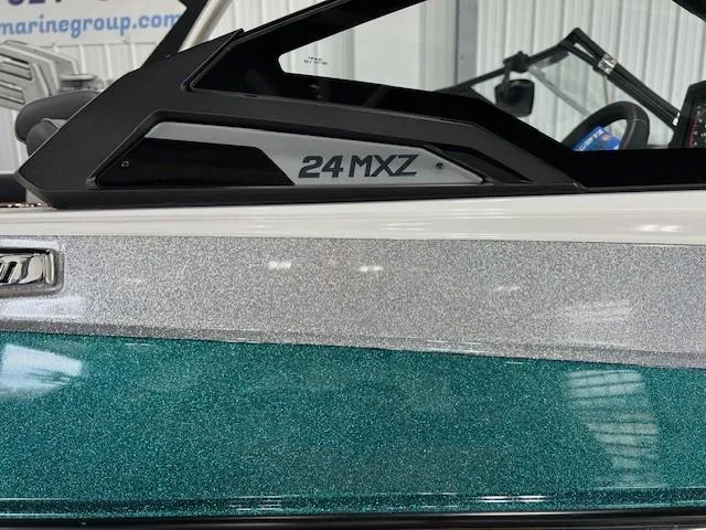 Slide: The Image of 2025 Malibu Wakesetter 24 MXZ boat with metallic teal and silver finish. - 5