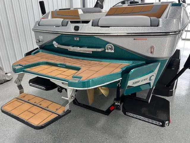 Slide: The Image of 2025 Malibu Wakesetter 24 MXZ boat with teak swim platform and sleek design. - 7