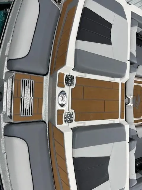 Slide: The Image of 2025 Malibu Wakesetter 24 MXZ interior with sleek gray and brown seating design. - 9