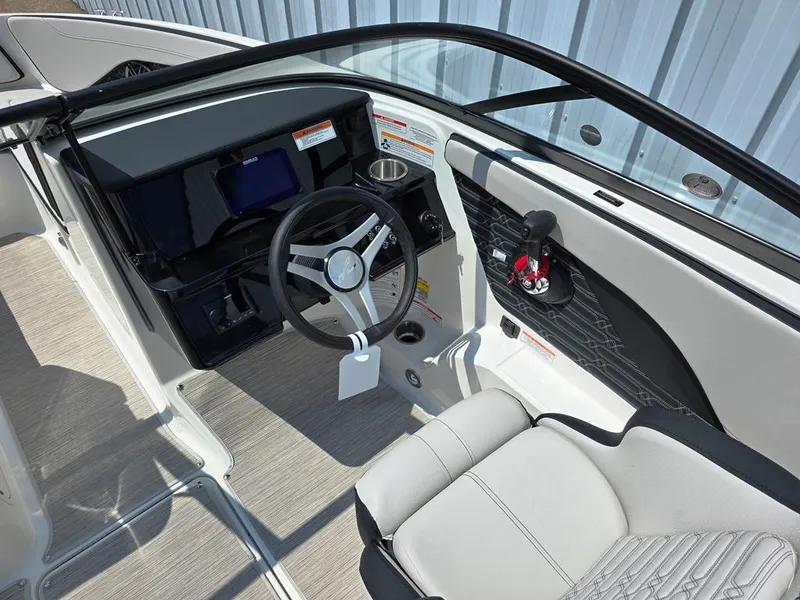 Slide: The Image of 2025 Sea Ray SPX 190 boat interior with steering wheel and dashboard. - 3