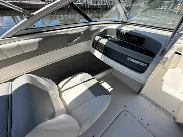 Slide: The Image of 2013 Bayliner 190 Bowrider interior with gray seating and dashboard. - 11