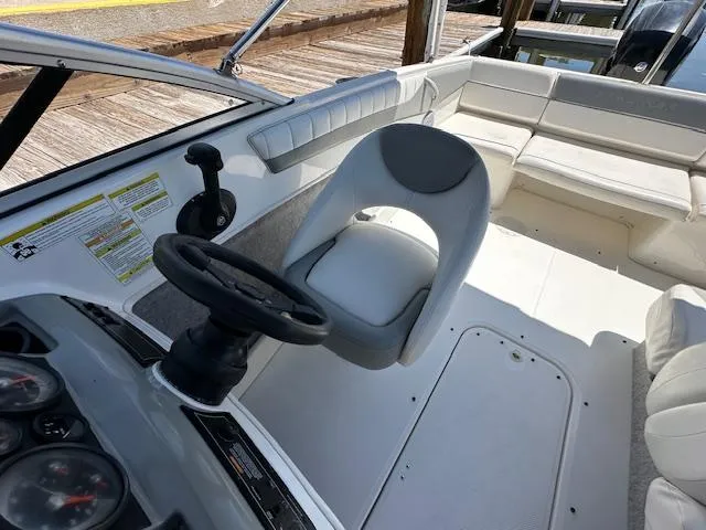 Slide: The Image of 2013 Bayliner 190 Bowrider interior with steering wheel and seating area. - 12