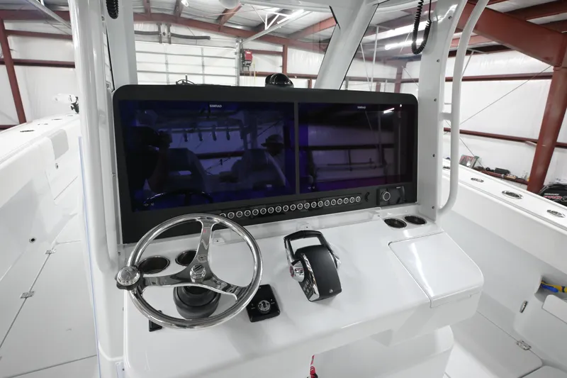 Slide: The Image of Dashboard of 2024 Freeman 43 boat with dual Simrad displays showing navigation data. - 10