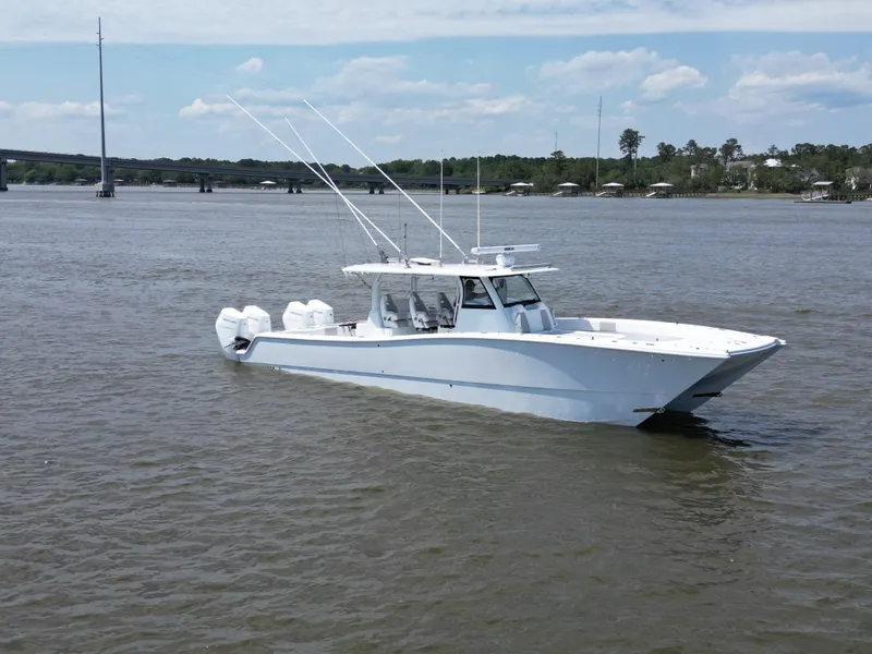 Slide: The Image of 2024 Freeman 43 boat cruising on open water, showcasing sleek design and powerful engines. - 2