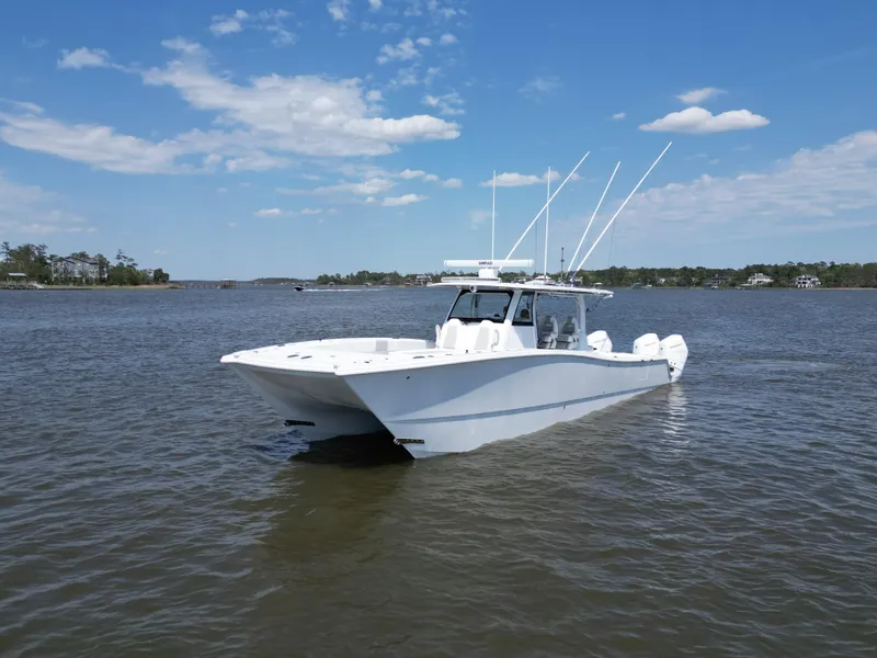 Slide: The Image of 2024 Freeman 43 boat on calm water under a clear blue sky. - 23