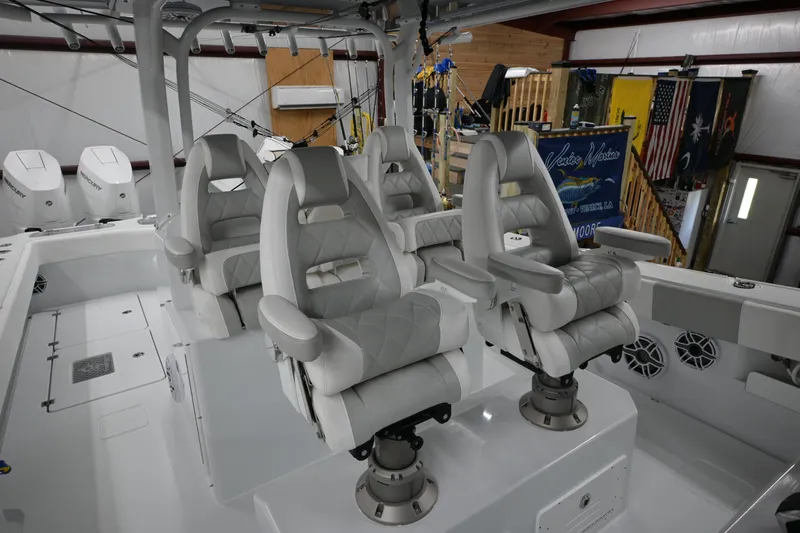 Slide: The Image of Luxurious seating on a 2024 Freeman 43 boat, featuring four plush captain's chairs. - 27