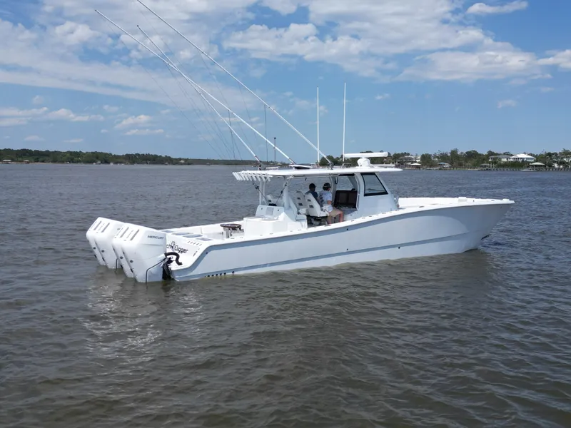 Slide: The Image of 2024 Freeman 43 boat cruising on water with bridge in background. - 3