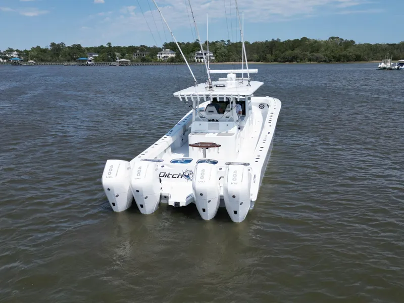 Slide: The Image of Aerial view of 2024 Freeman 43 boat cruising on green water. - 5