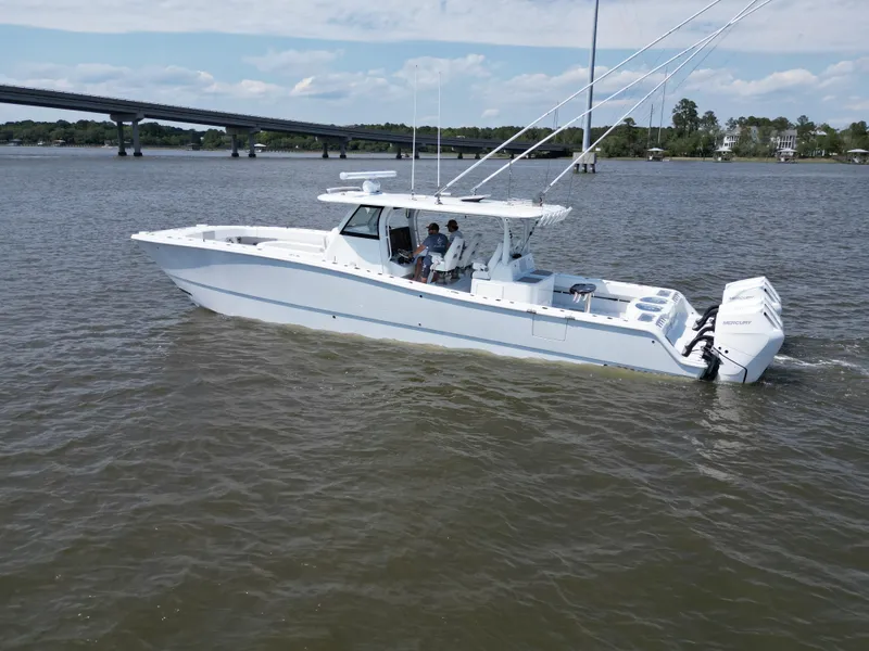 Slide: The Image of 2024 Freeman 43 boat cruising on open water with four powerful engines. - 6