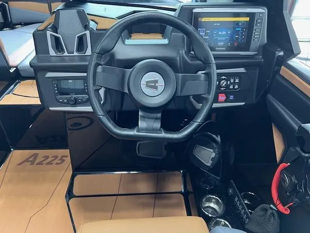 Slide: The Image of 2024 Axis A225 boat dashboard with steering wheel and digital display. - 14