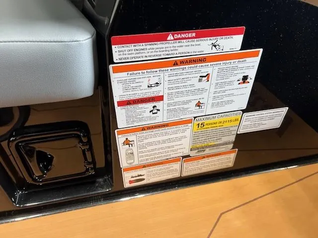 Slide: The Image of Warning labels on 2024 Axis A225 boat, highlighting safety instructions and maximum capacity. - 18