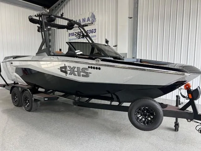 Slide: The Image of 2024 Axis A225 boat on trailer in showroom, featuring sleek design and modern features. - 2