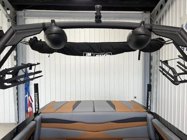 Slide: The Image of 2024 Axis A225 boat interior with speakers and wakeboard racks in a garage. - 20