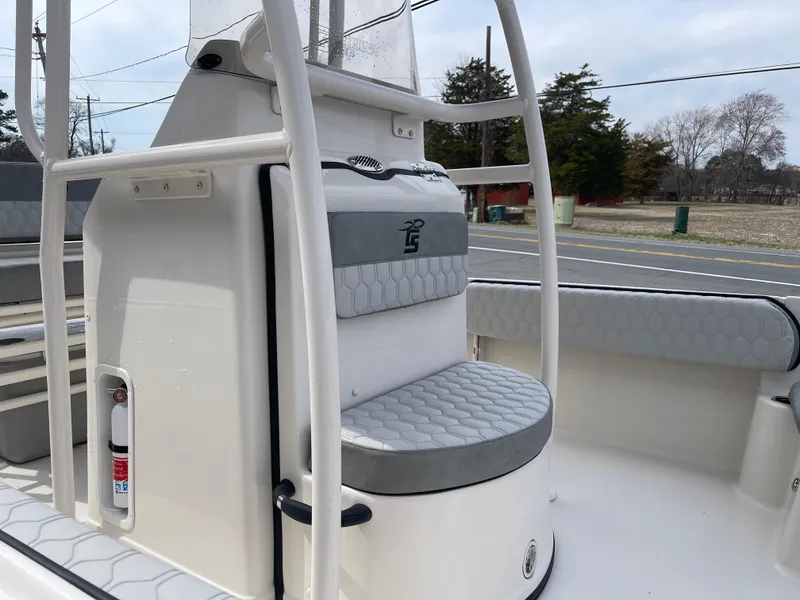 Slide: The Image of 2025 Carolina Skiff 21 Ultra Elite boat interior with gray seating and speaker. - 12
