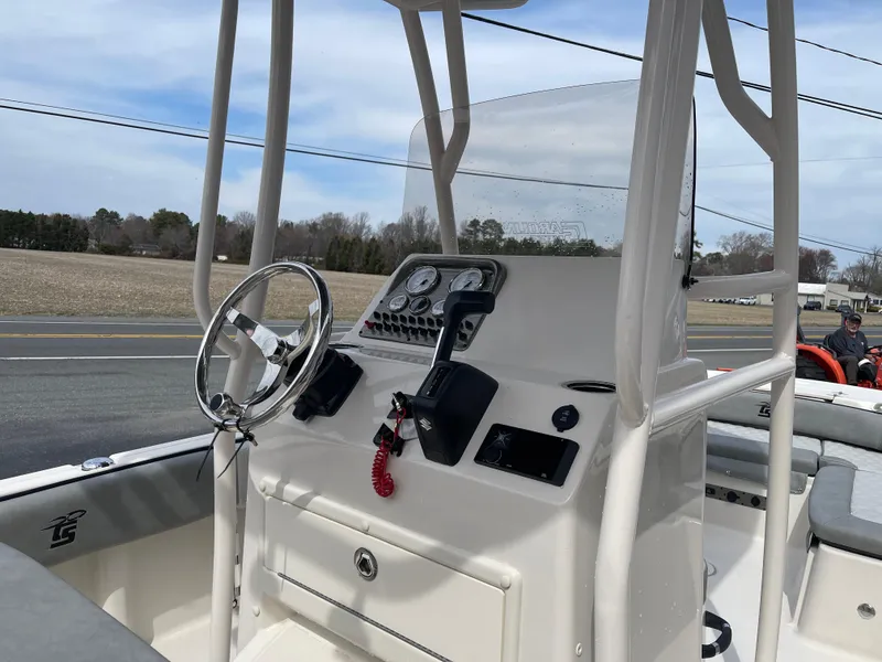Slide: The Image of 2025 Carolina Skiff 21 Ultra Elite boat console with steering wheel and controls. - 21