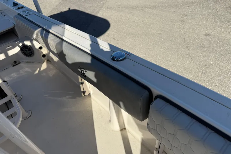 Slide: The Image of 2025 Carolina Skiff 21 Ultra Elite boat interior with padded seating and speaker. - 25