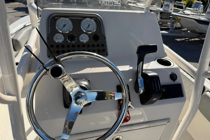 Slide: The Image of 2025 Carolina Skiff 21 Ultra Elite boat dashboard with steering wheel and controls. - 28