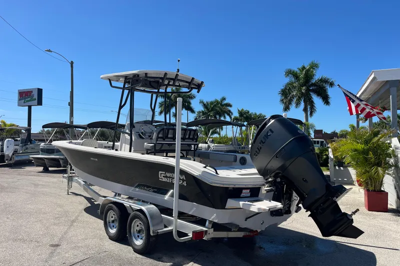 Slide: The Image of 2025 Carolina Skiff 24 Ultra Elite boat with Suzuki outboard motor on trailer. - 12