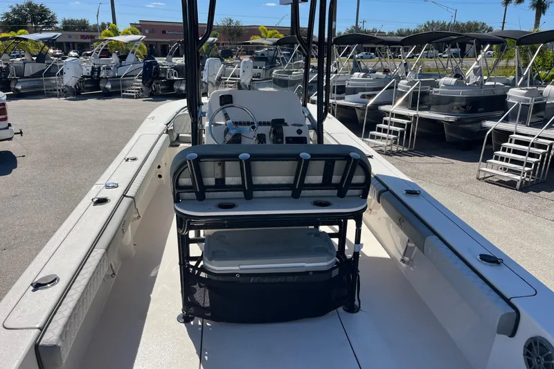 Slide: The Image of 2025 Carolina Skiff 24 Ultra Elite boat interior with seating and steering console. - 13