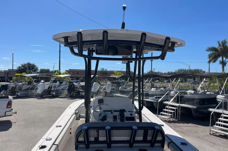 Slide: The Image of 2025 Carolina Skiff 24 Ultra Elite boat displayed in a sunny outdoor showroom. - 14