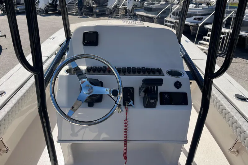 Slide: The Image of 2025 Carolina Skiff 24 Ultra Elite boat console with steering wheel and controls. - 15
