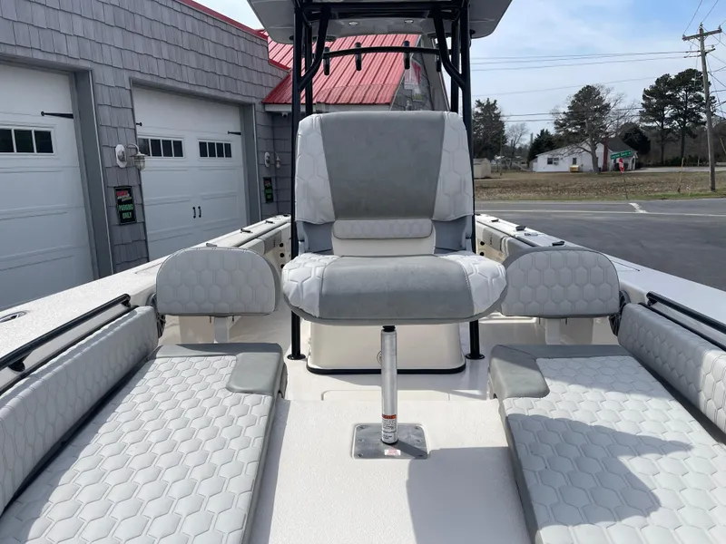 Slide: The Image of 2025 Carolina Skiff 24 Ultra Elite boat interior with gray seating and modern design. - 16