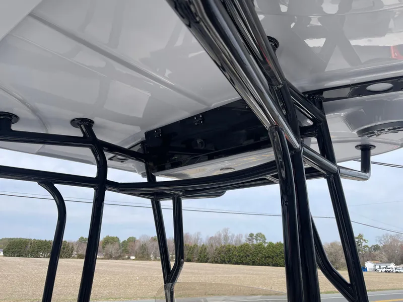 Slide: The Image of 2025 Carolina Skiff 24 Ultra Elite T-top frame, showcasing sturdy black metal structure. - 17