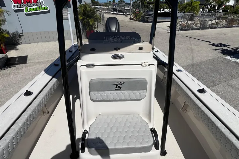 Slide: The Image of 2025 Carolina Skiff 24 Ultra Elite boat interior with seating and console. - 19