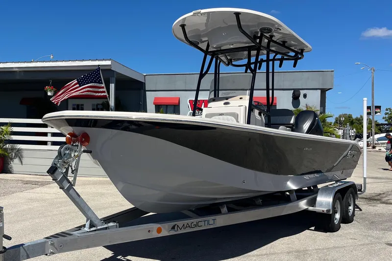 Slide: The Image of 2025 Carolina Skiff 24 Ultra Elite boat on trailer, parked outdoors. - 2