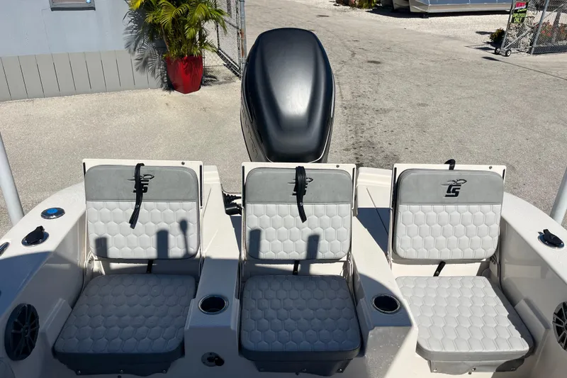 Slide: The Image of 2025 Carolina Skiff 24 Ultra Elite boat seats with gray cushions and cup holders. - 20