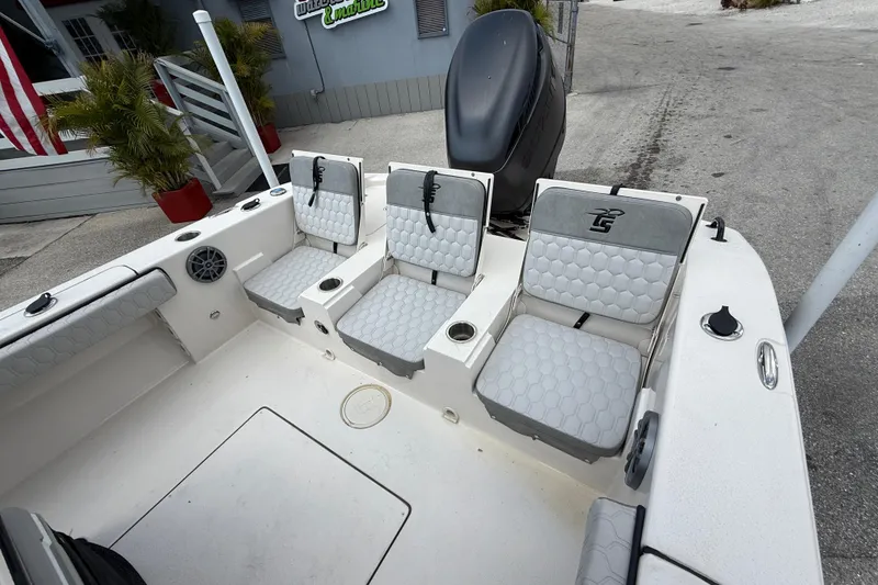 Slide: The Image of 2025 Carolina Skiff 24 Ultra Elite boat interior with cushioned seating and modern design. - 23