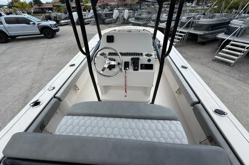 Slide: The Image of 2025 Carolina Skiff 24 Ultra Elite boat interior with steering console and seating. - 24