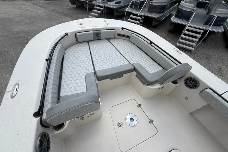 Slide: The Image of 2025 Carolina Skiff 24 Ultra Elite boat with gray cushioned seating and storage compartments. - 25