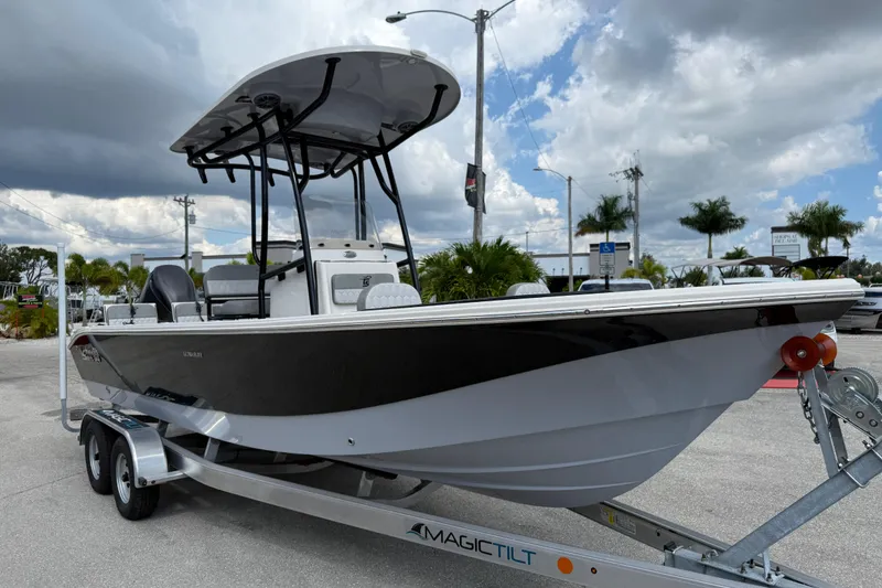 Slide: The Image of 2025 Carolina Skiff 24 Ultra Elite boat on trailer under cloudy sky. - 4