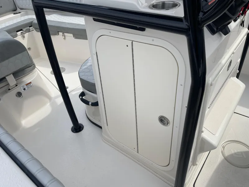 Slide: The Image of 2025 Sea Chaser 22 HFC boat interior with seating and Suzuki outboard motor. - 10