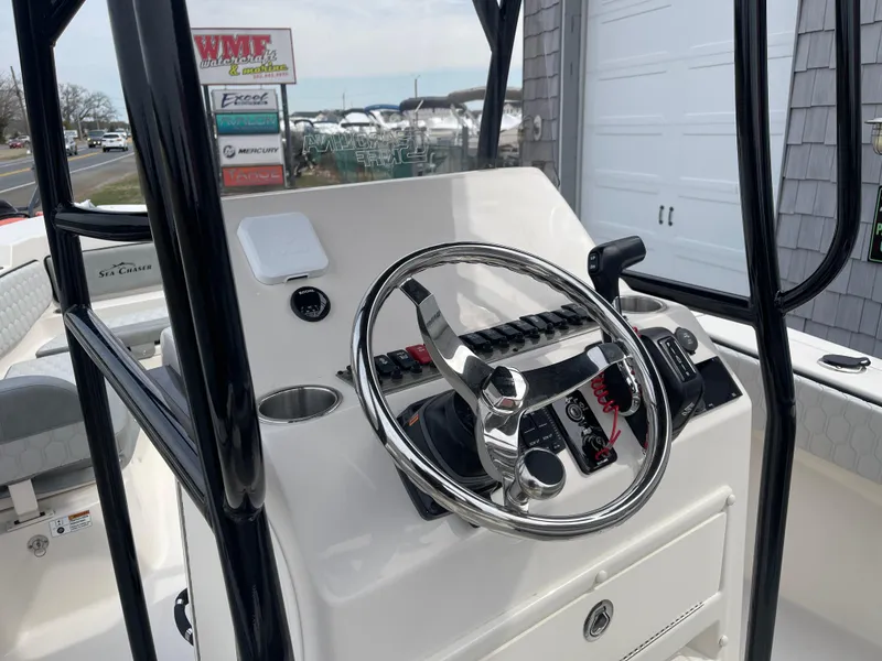 Slide: The Image of 2025 Sea Chaser 22 HFC boat interior with seating and control panel. - 11