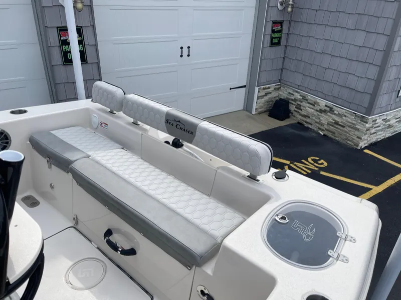 Slide: The Image of 2025 Sea Chaser 22 HFC boat interior with gray cushioned seating. - 12