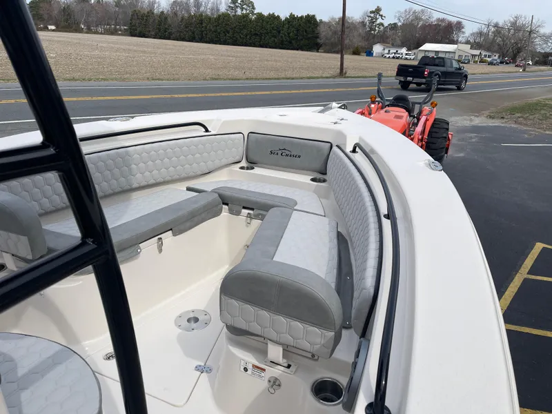 Slide: The Image of 2025 Sea Chaser 22 HFC boat interior with cushioned seating and storage compartments. - 13