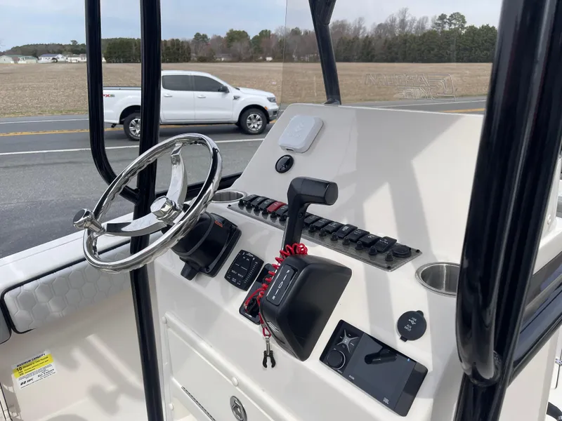 Slide: The Image of 2025 Sea Chaser 22 HFC boat interior with seating and steering console. - 14