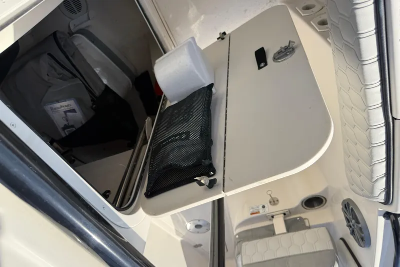 Slide: The Image of Interior view of 2025 Sea Chaser 22 HFC boat with storage compartment and seating. - 20