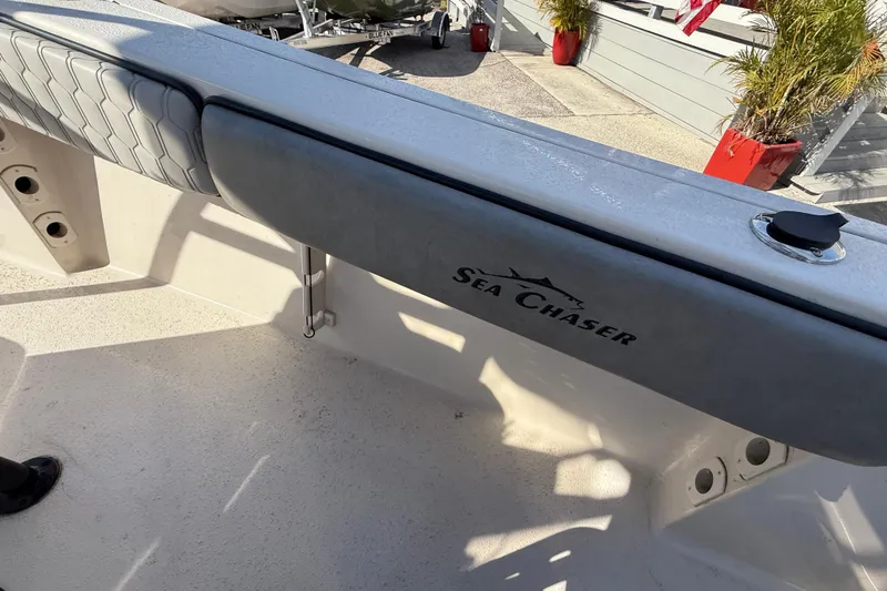 Slide: The Image of 2025 Sea Chaser 22 HFC boat interior with logo and seating detail. - 21