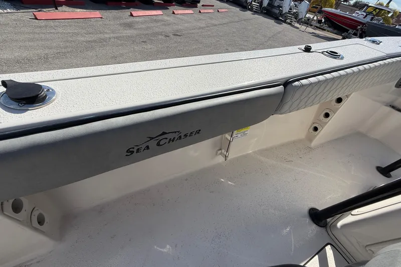 Slide: The Image of 2025 Sea Chaser 22 HFC boat interior with padded seating and rod holders. - 22