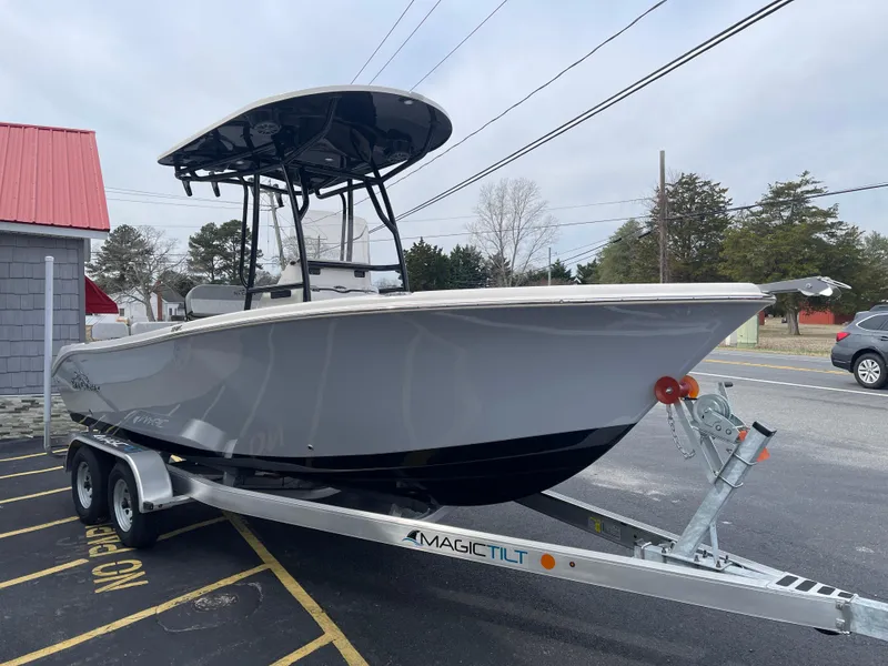 Slide: The Image of 2025 Sea Chaser 22 HFC boat with Suzuki engine on trailer, parked outdoors. - 4