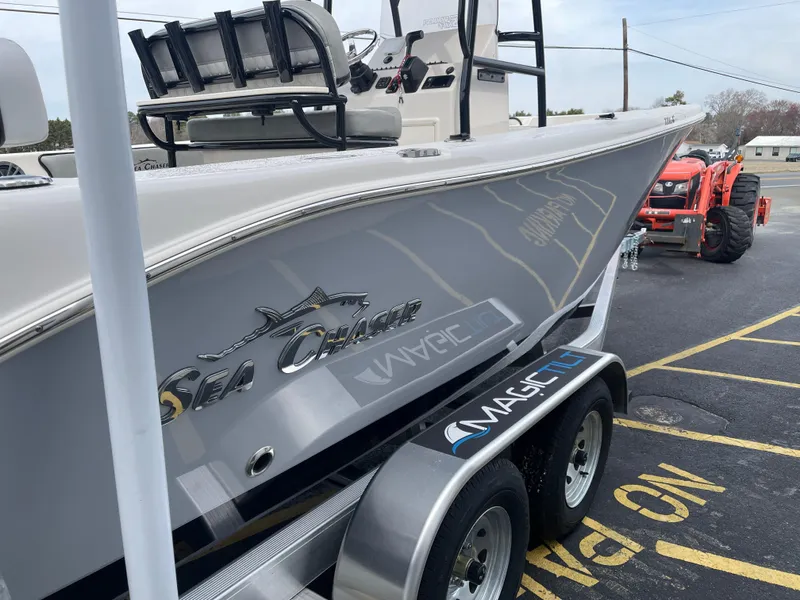 Slide: The Image of 2025 Sea Chaser 22 HFC boat with powerful outboard motor, parked outdoors. - 5