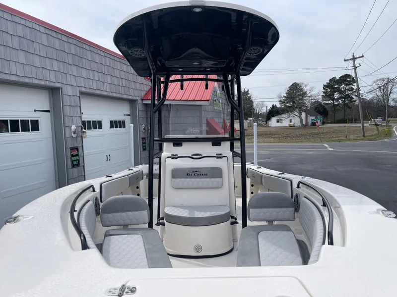 Slide: The Image of 2025 Sea Chaser 22 HFC boat with powerful outboard motor, parked outdoors. - 6